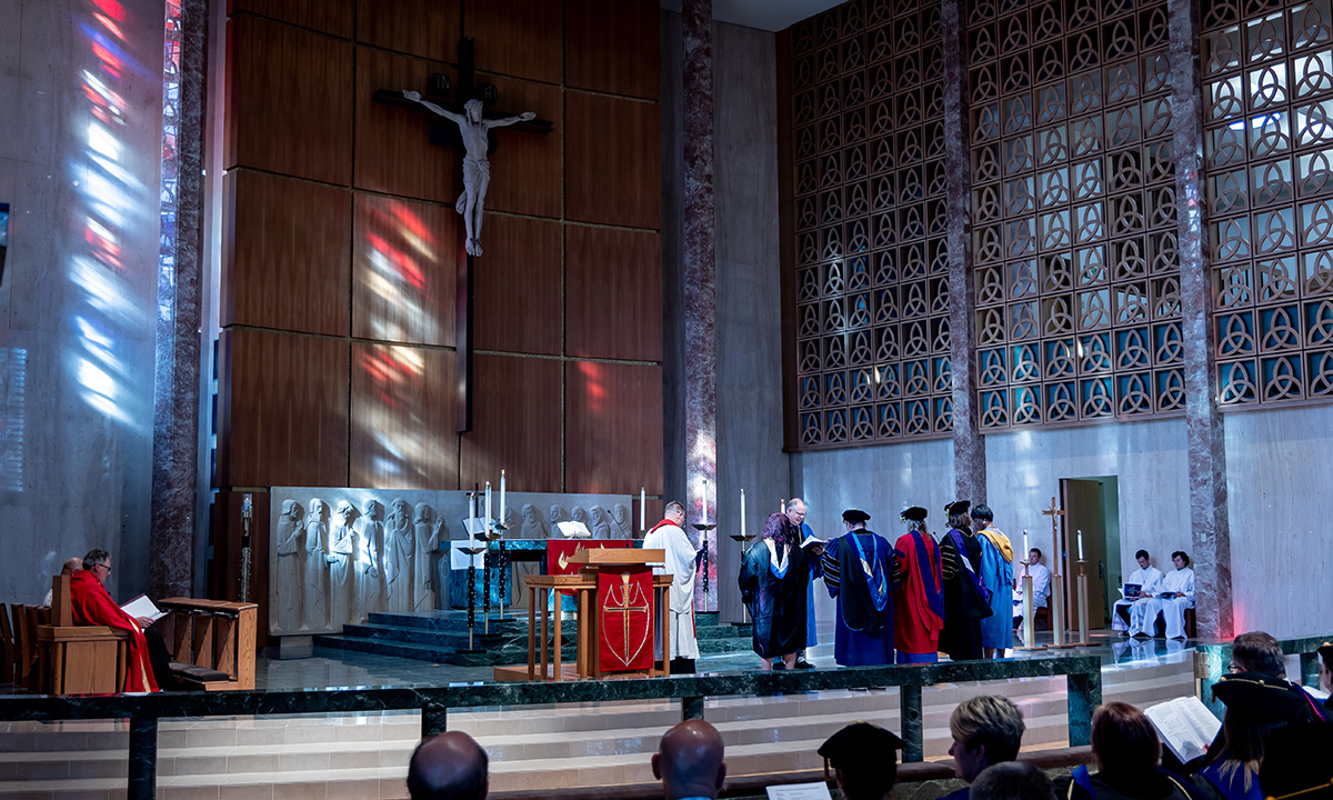 people in chapel being installed