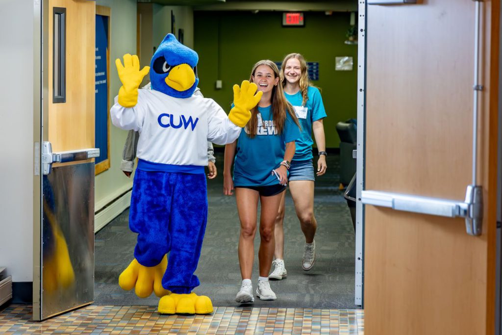 Freddy the Falcon walking with students