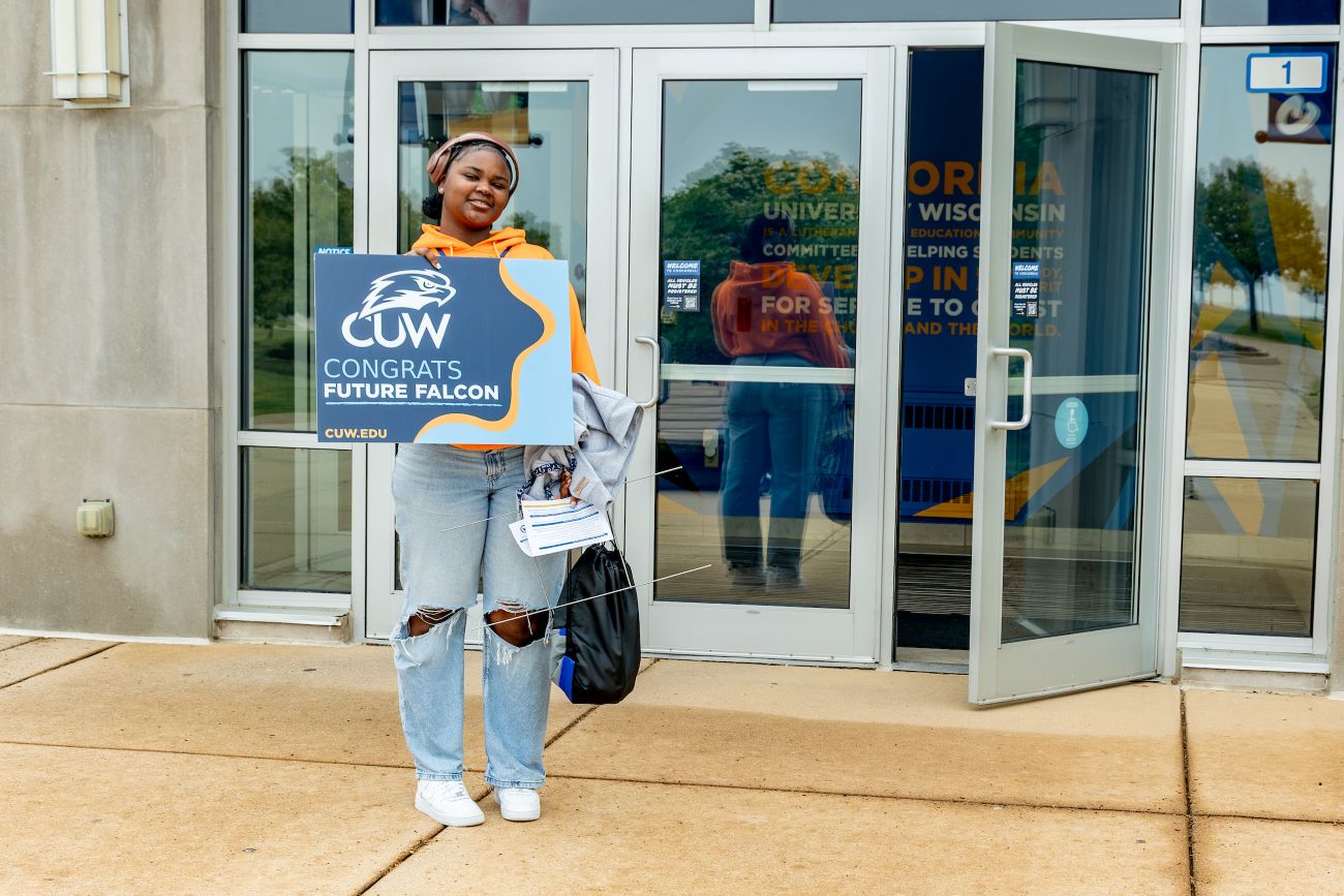 woman holding sign Future Falcon