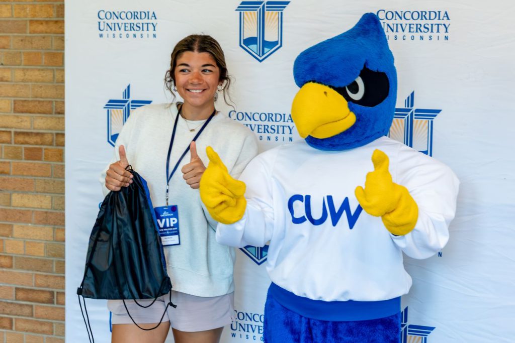 woman posing with Falcon mascot