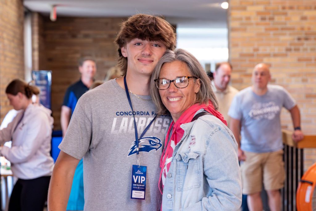 son posing with parent