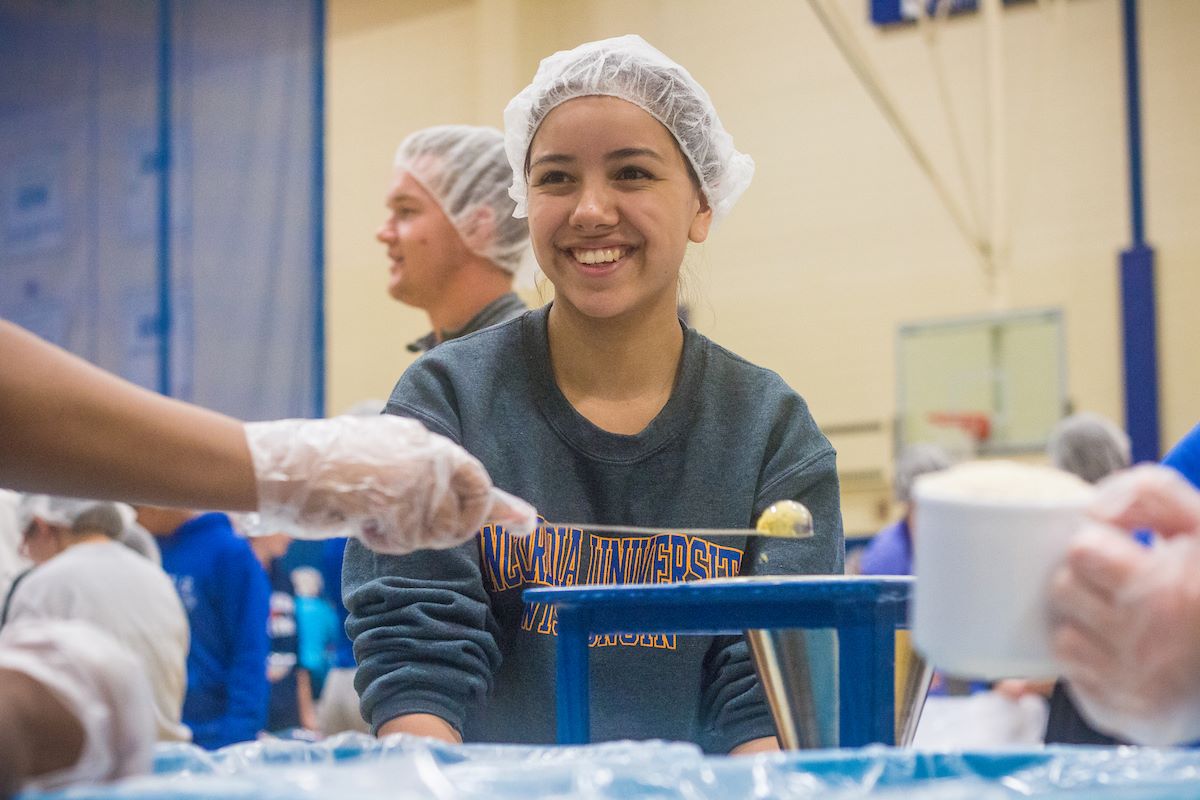 girl with hair net packing food