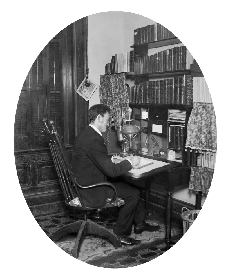 black and white photo of man sitting at a desk.
