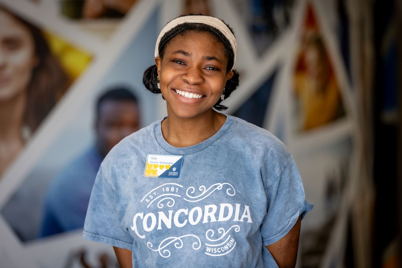 girl with gray shirt and headband smiling