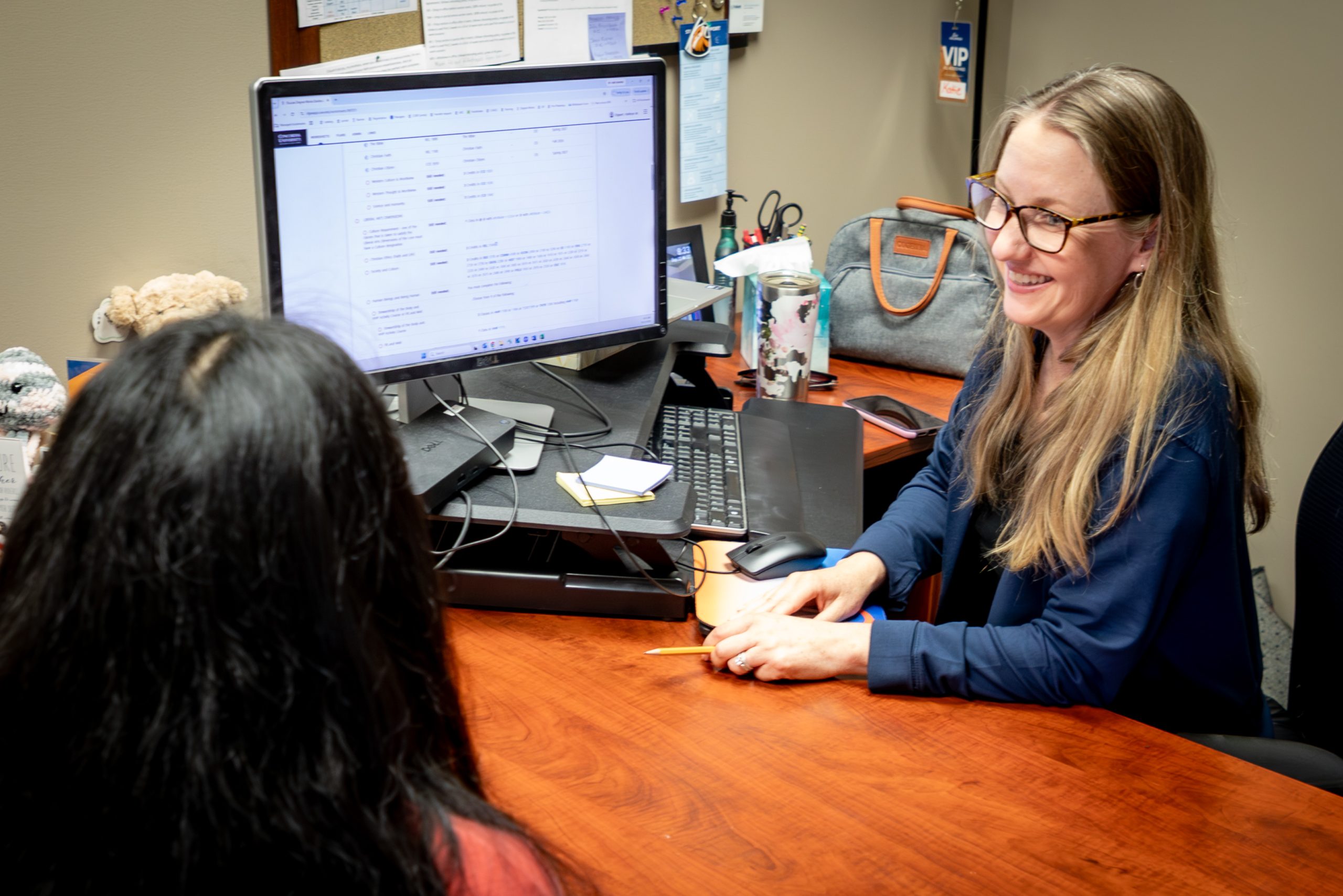 woman by computer with student