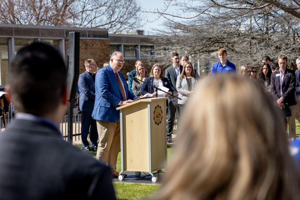 Dr. Ankerberg at a podium talking to crowd