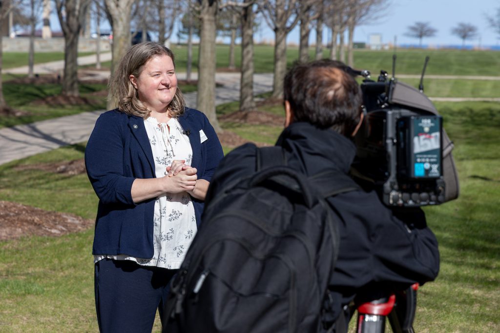 Man with camera interviewing Dr. Leiberg
