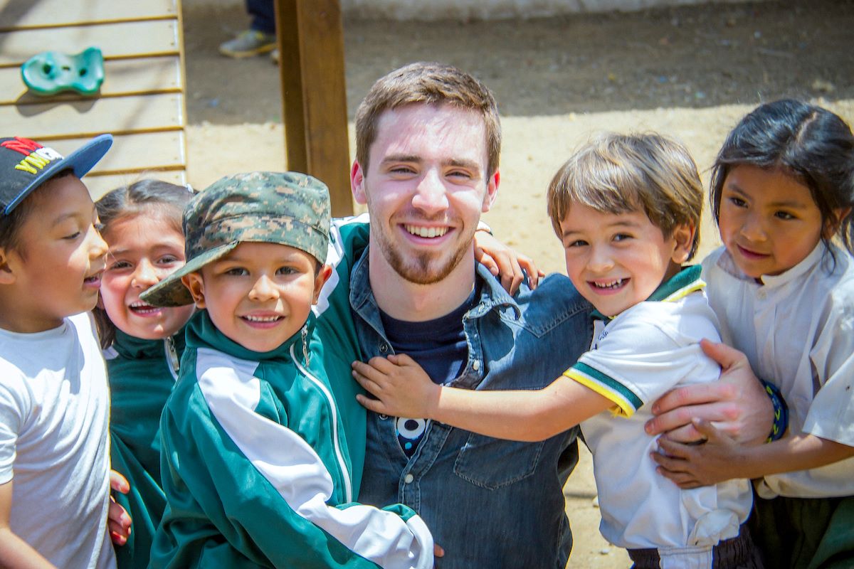man surrounded by children