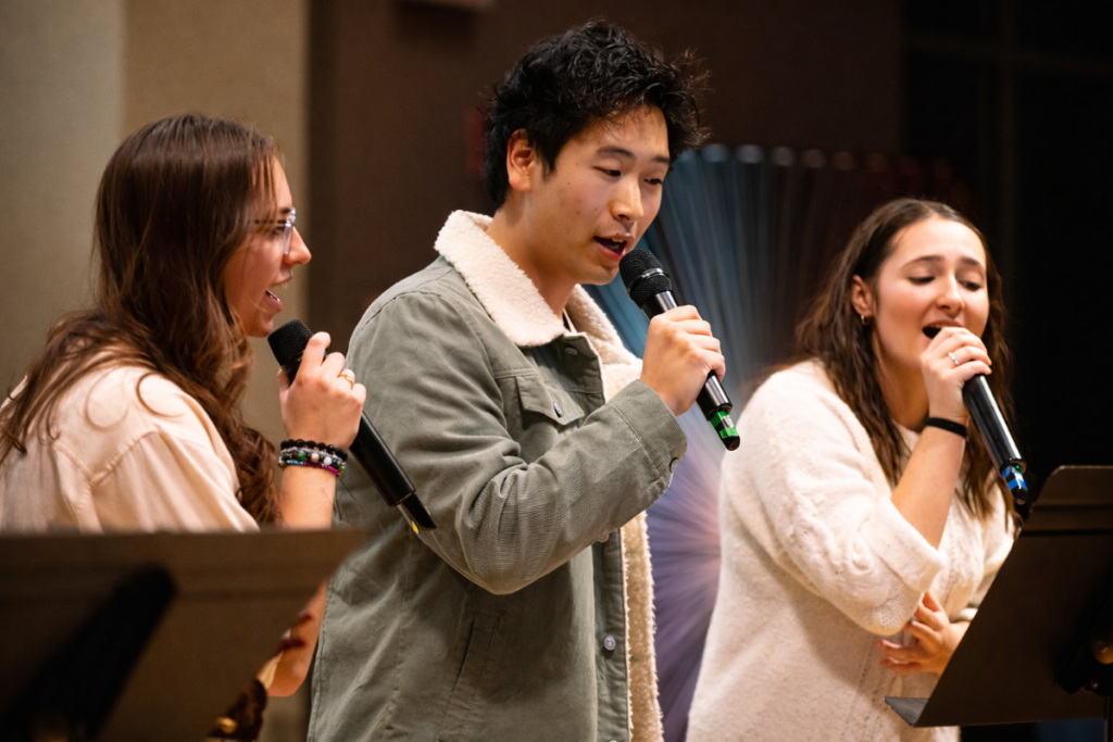 three students singing