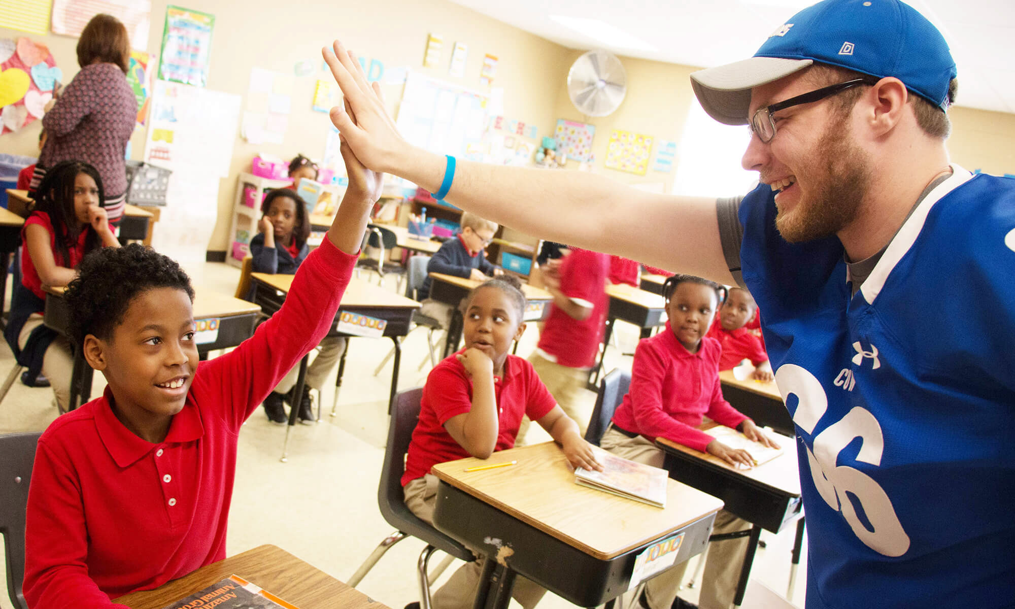 A CUW student gives a student from Northwest Lutheran a high-five on April 19 during a 