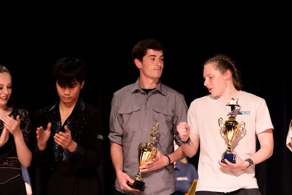 two men holding awards