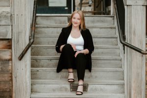 girl sitting on stairs in suit