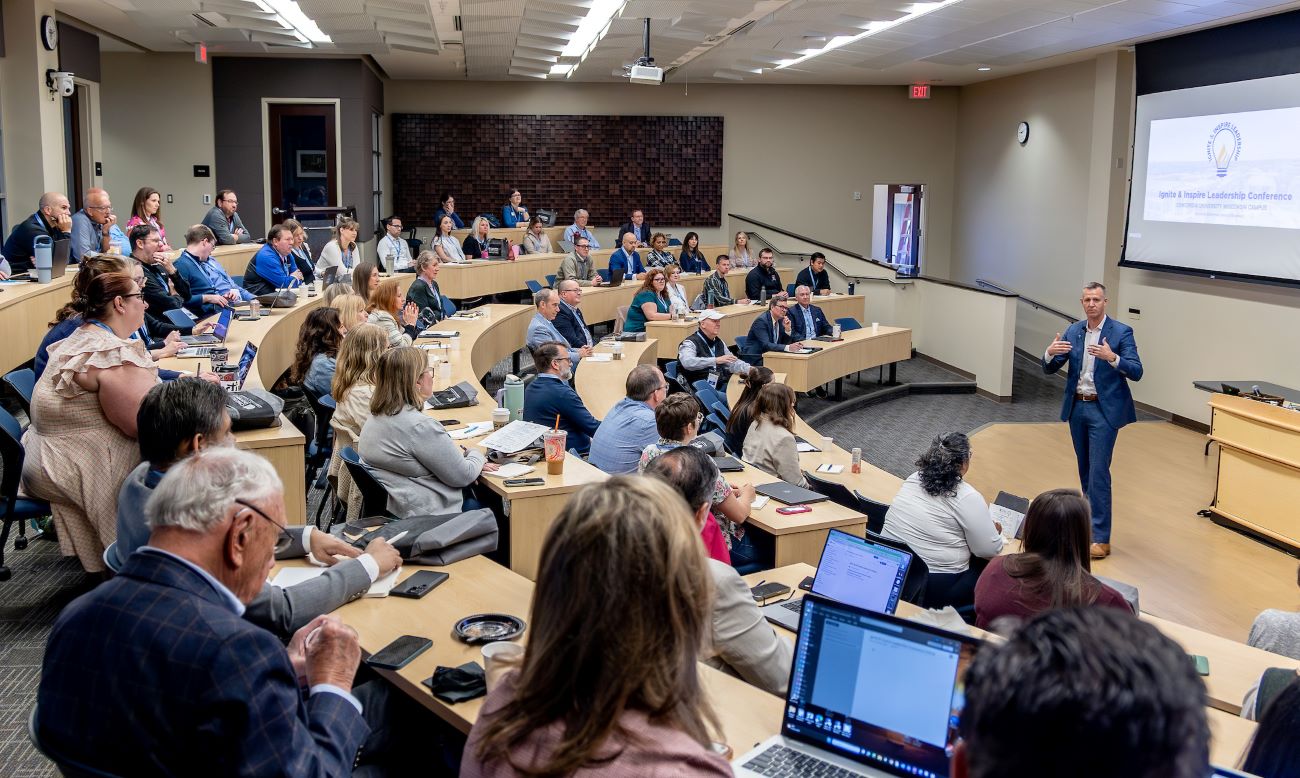 room with people listening to speaker