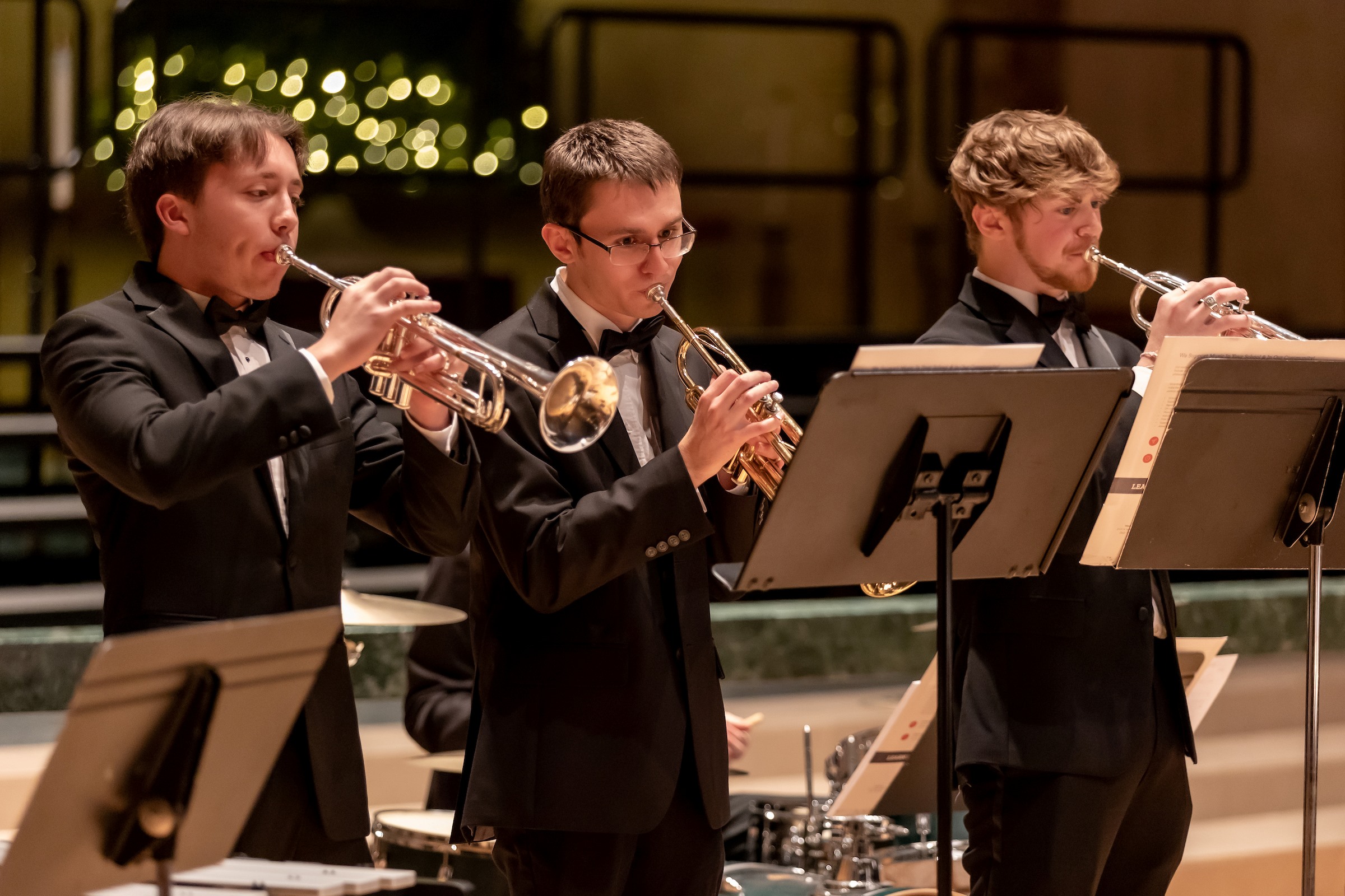 three guys playing trumpets