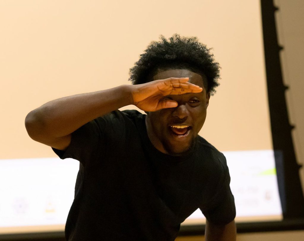 man with hand over eyes