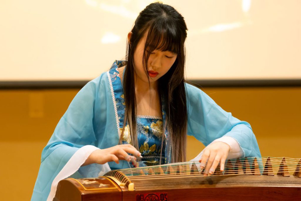 woman playing asian instrument