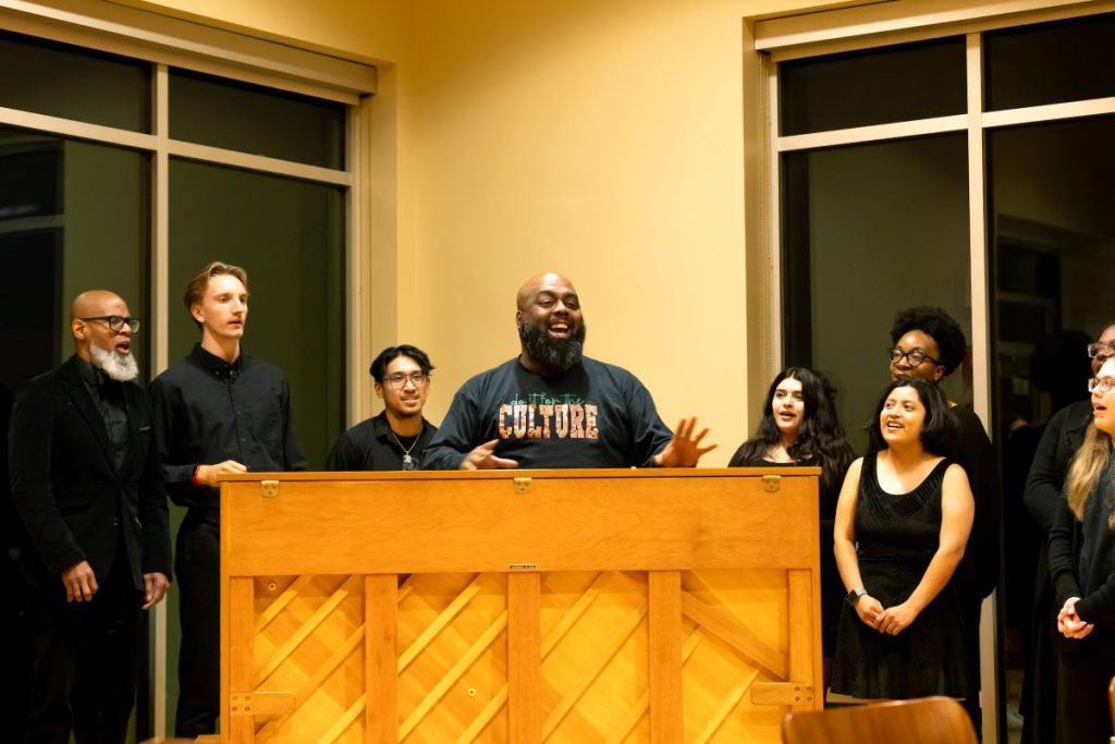 men and women speaking at podium