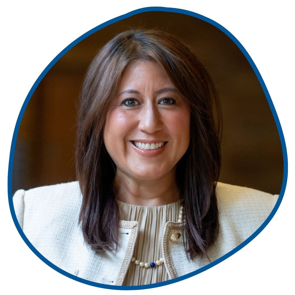woman with dark hair and white jacket