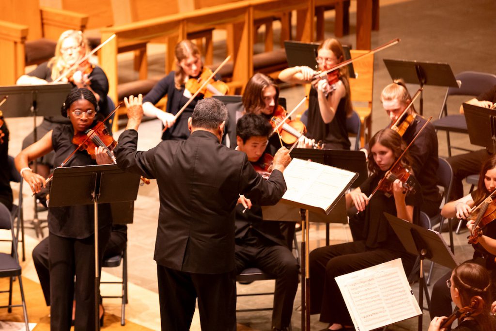 Violins playing in front of conductor