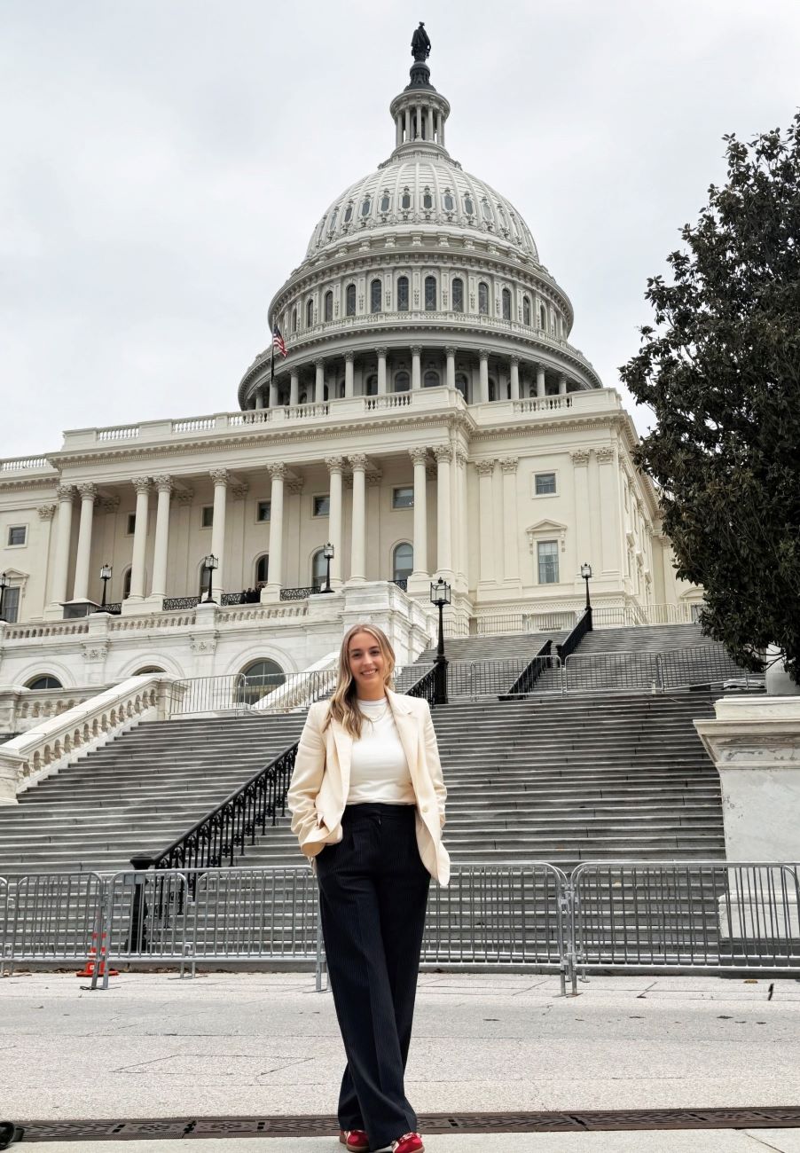 woman dressed professionally in front of Capital