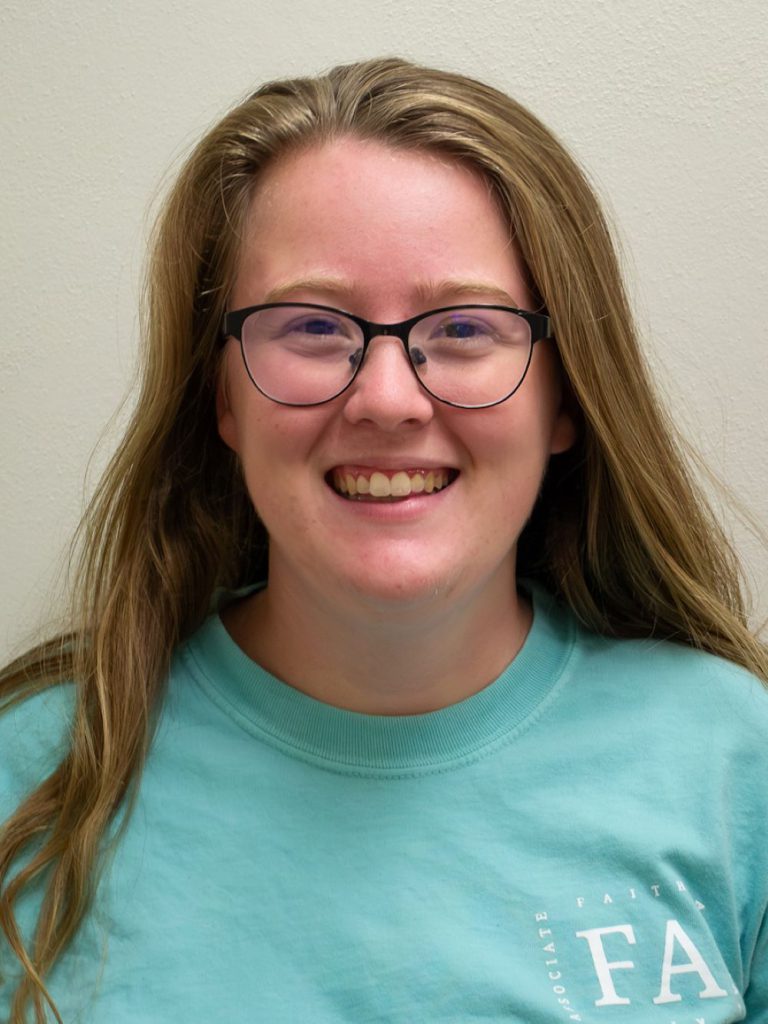 girl with brown hair and glasses