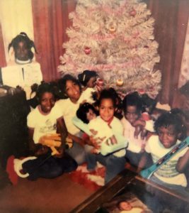 girls under tree holding dolls