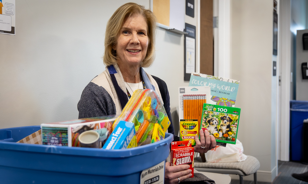 woman with short blonde hair holding supplies