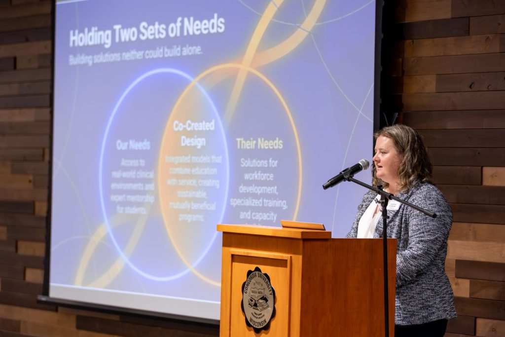 woman at podium using powerpoint
