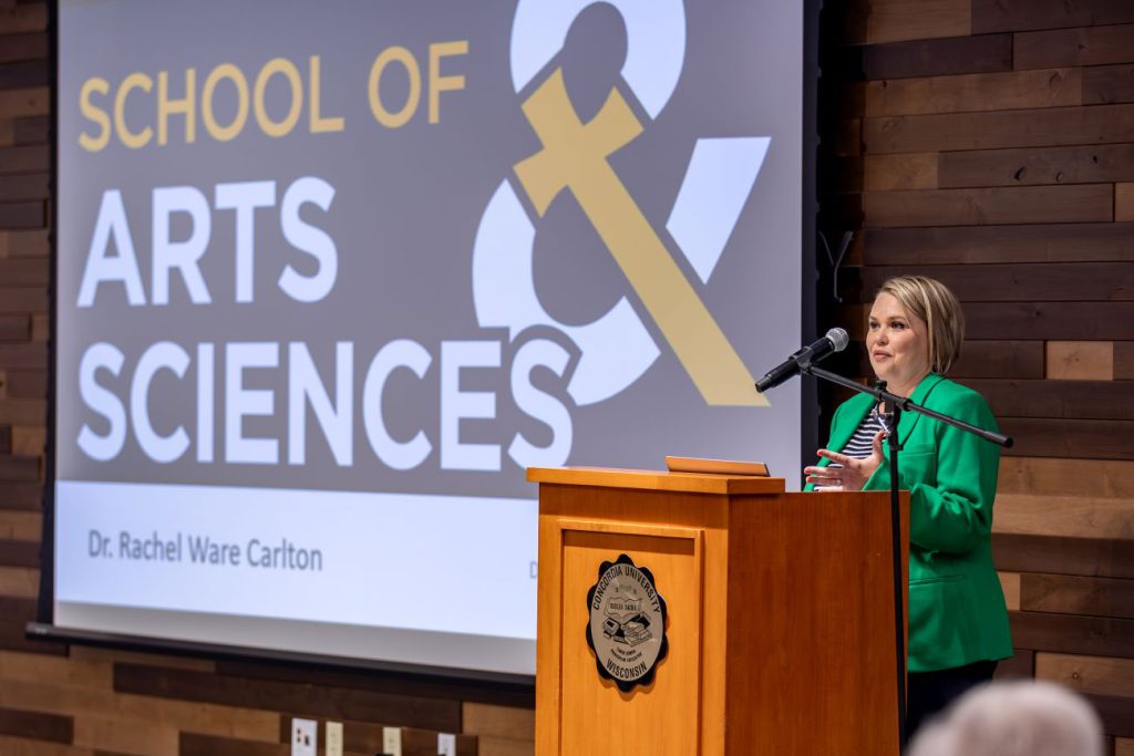 woman in green at podium