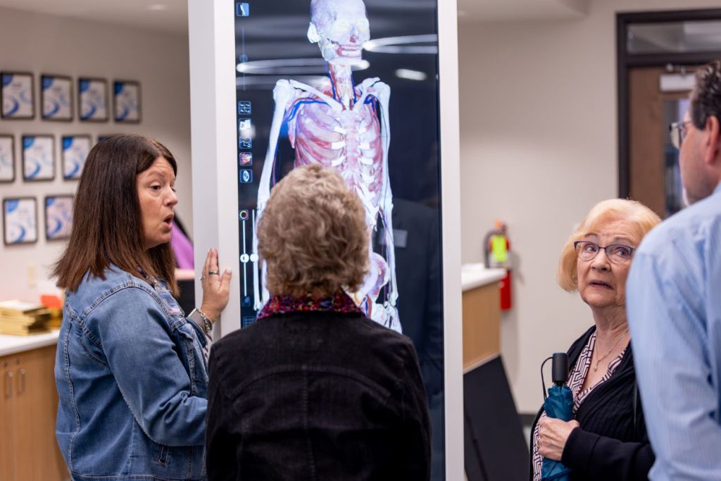 people looking at anatomage table