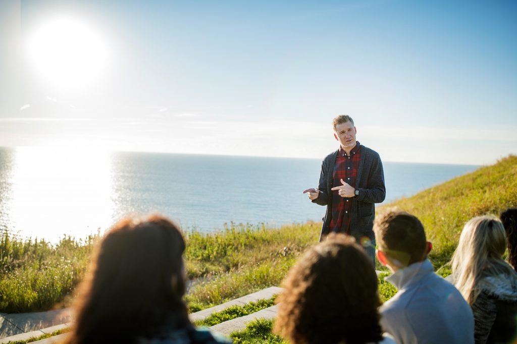 A professor teaches a class outside on the bluff on the CUW campus.