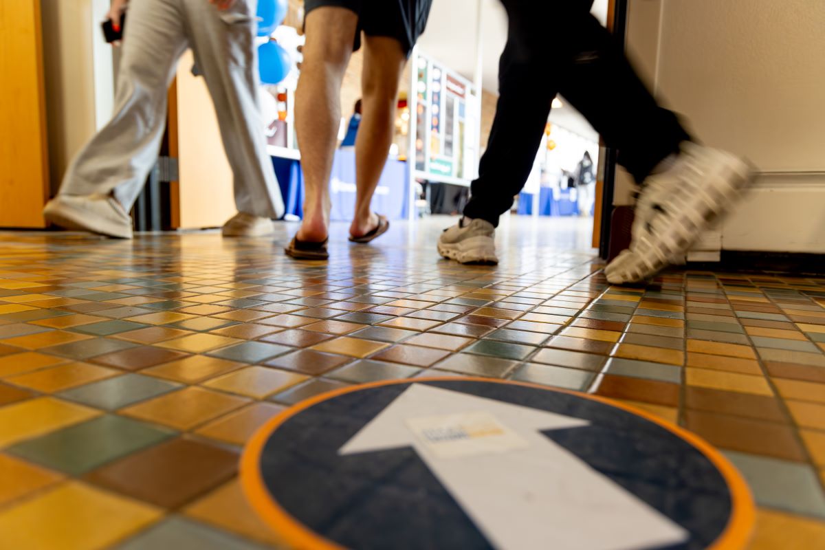 students walking in direction of arrow