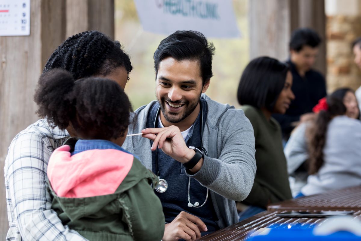man checking temperature on infant