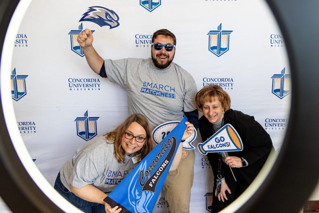 Group of 3 cheering on CUW