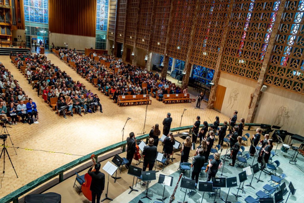 people in chapel watching concert