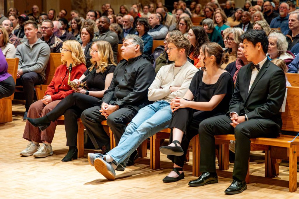 people sitting and watching concert