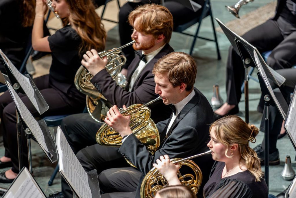 closeup of students playing trombones