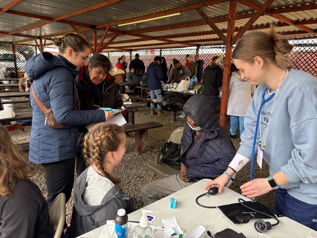 students working with local patients