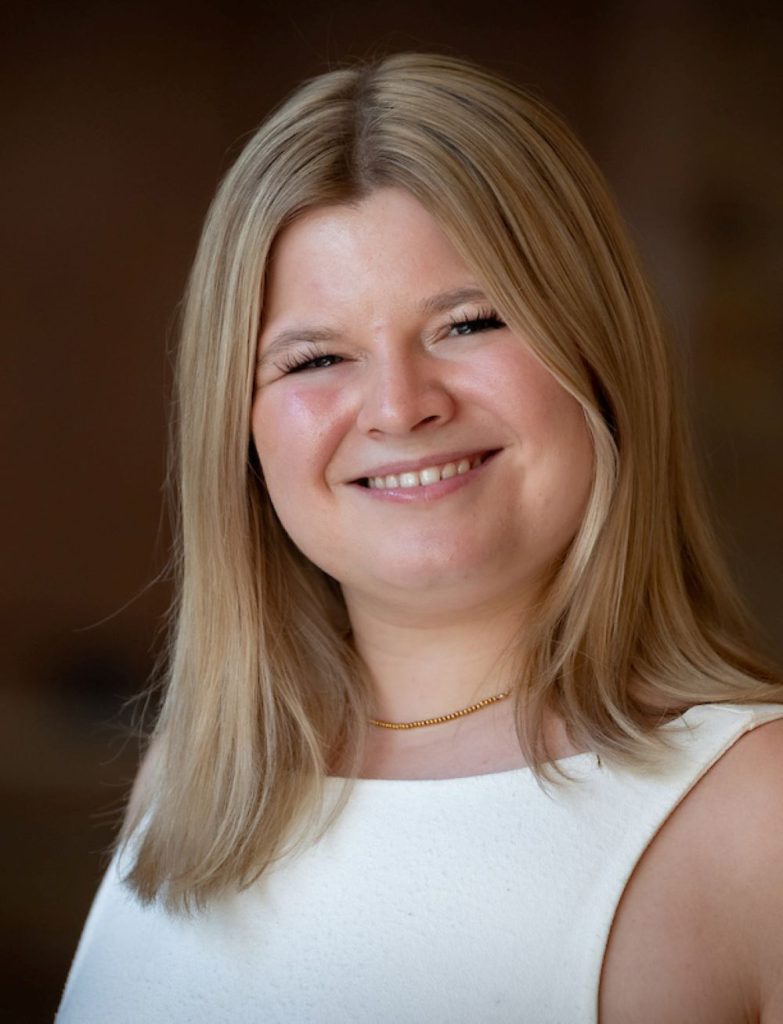 woman with blonde hair and white tank top