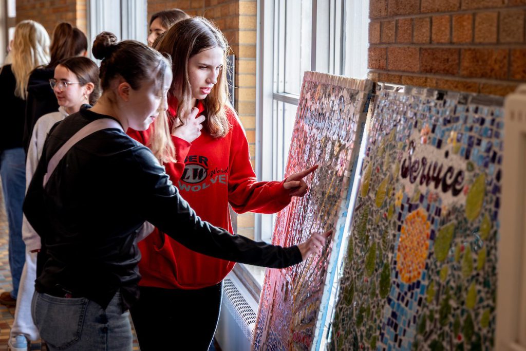 two girls looking at art