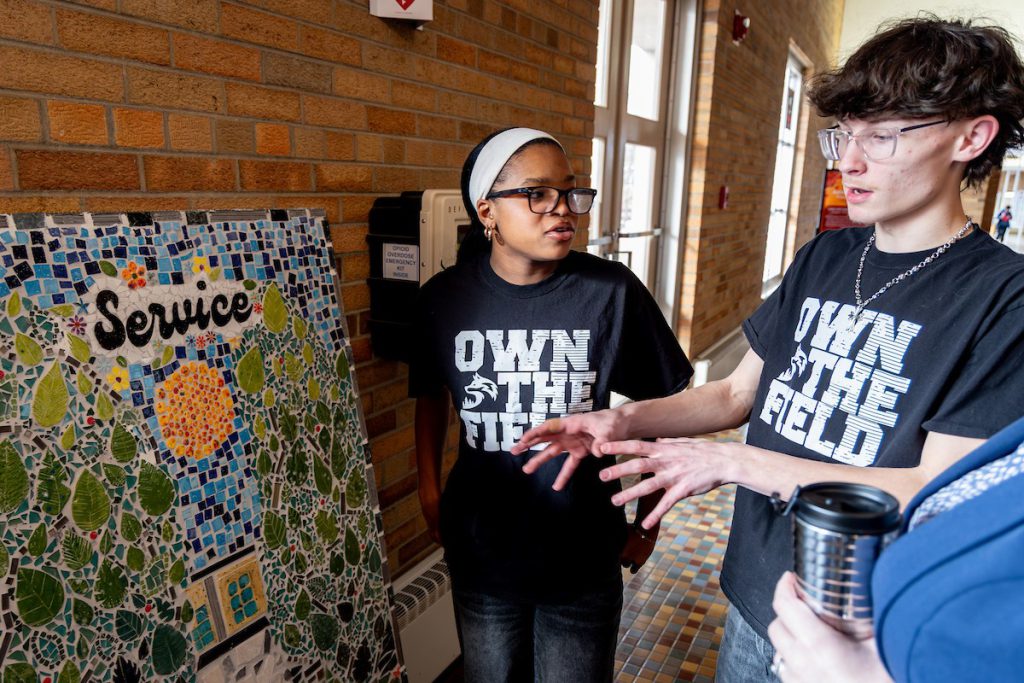two students looking at art