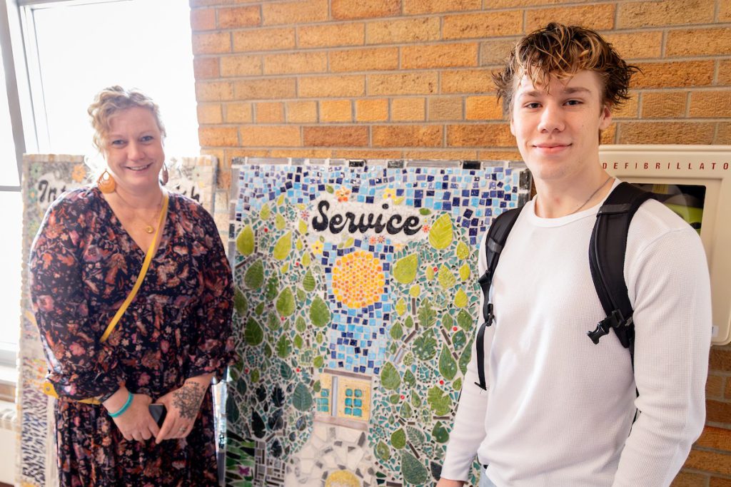 Mother and son standing by art