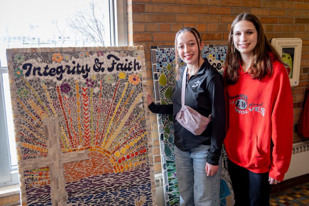 Students standing by art