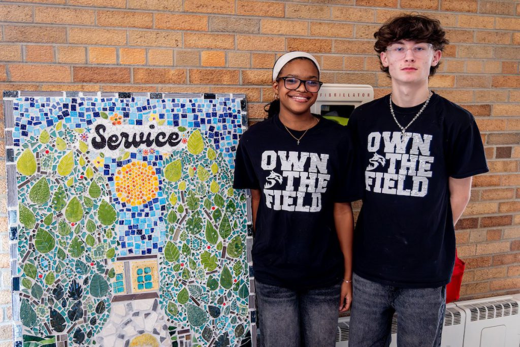 Students standing by art