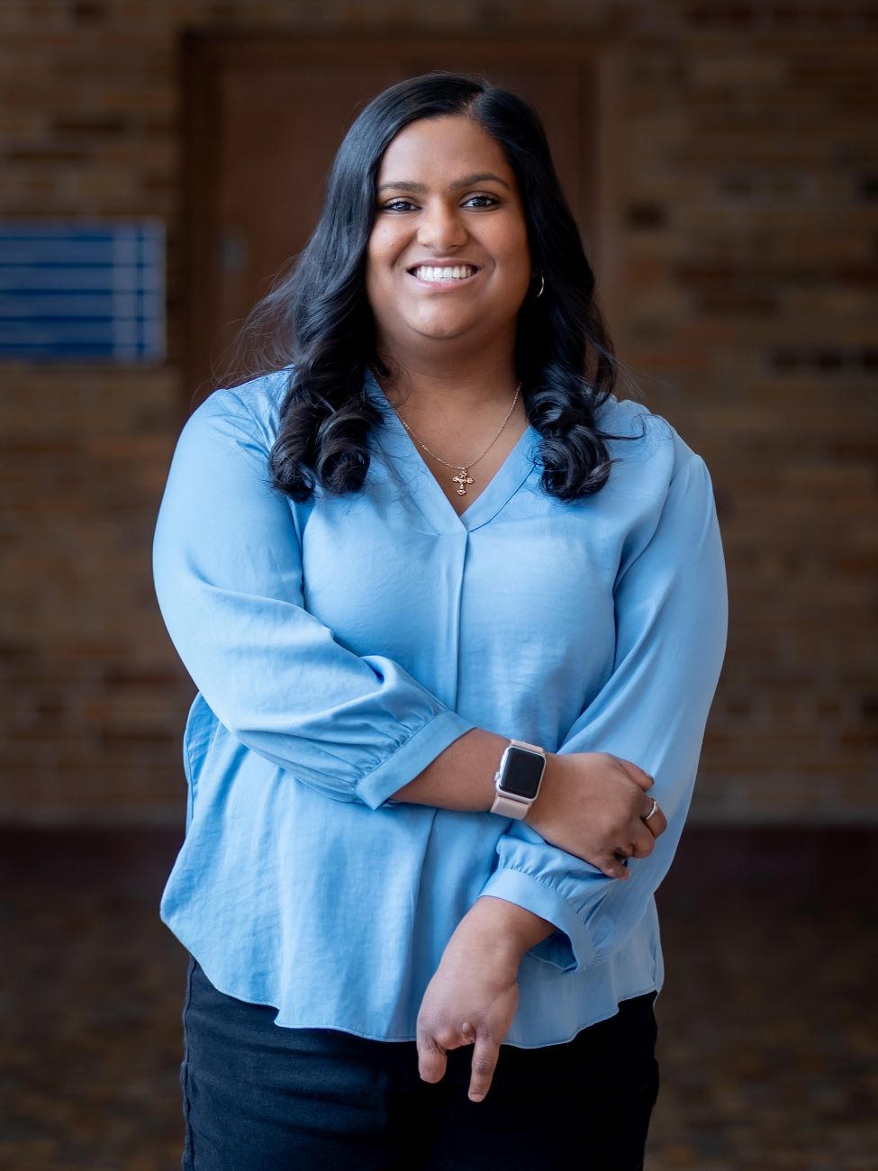 woman in blue holding her arm