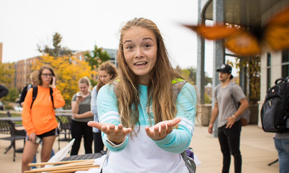 girl looking at camera with hands open