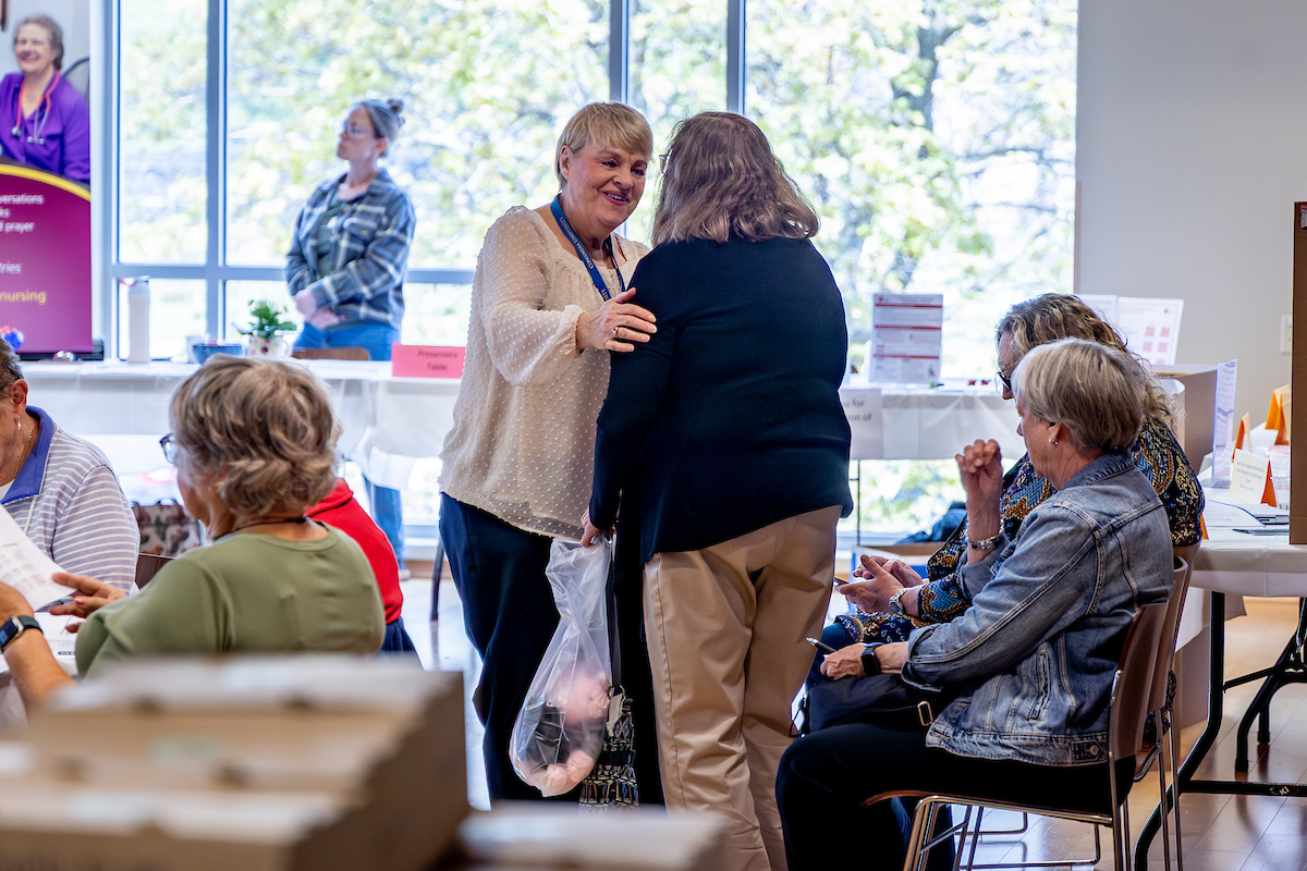 Carol Lueders Bolwerk chatting with an attendee