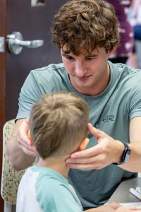 Student nurse working with a child