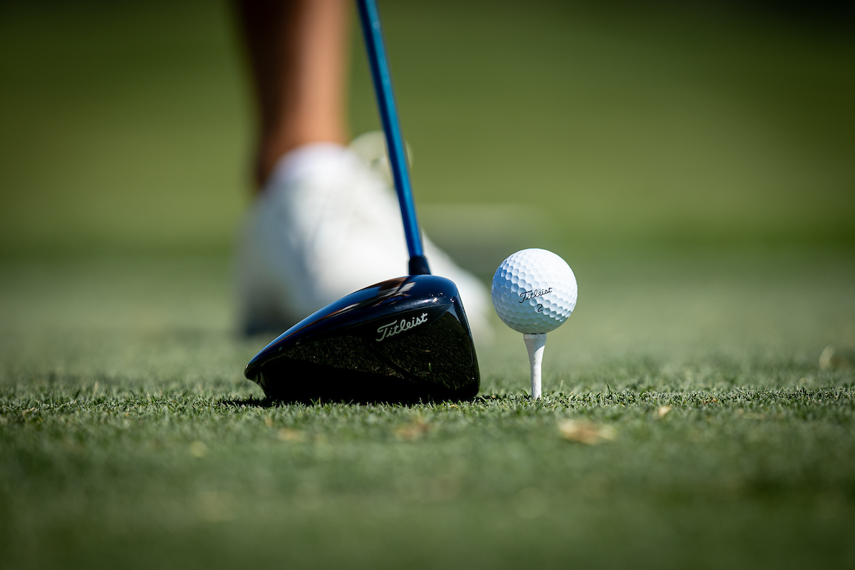 golf ball and club and man's foot