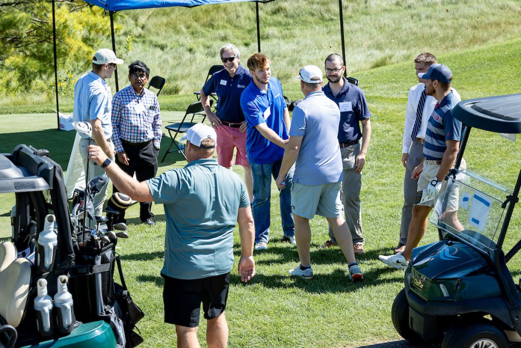 people in group shaking hands